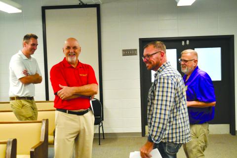 Enoch Autry/The Clayton Tribune. New Clayton mayor Roy Quilliams (center) shares a laugh with Mayor Pro Tem Stacy Fountain at the conclusion of the Clayton City Council meeting on Sept. 9. The council voted in favor of Quilliams filling the unexpired term of former mayor Kurt Cannon, who resigned in June.