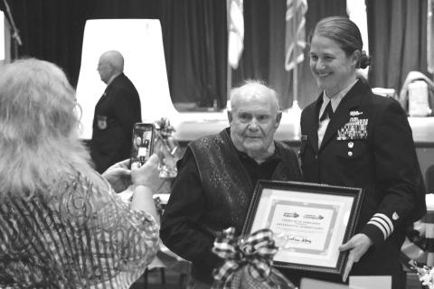 File photo. Enoch Autry/The Clayton Tribune, Kathy Causey takes a photograph of her father Eldrid Causey with Commander Sarah Ernst at the conclusion of the 24th Annual Veterans Appreciation Dinner on Nov. 9, 2023, at the Rabun County Civic Center. Ernst told the audience about Causey, then 99, who served in WWII and was the oldest veteran at the event. Causey, a Rabun County resident, died on Sept. 5, 2025, at the age of 101.