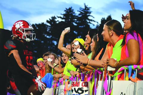 Enoch Autry/The Clayton Tribune. Rabun County senior Reid Giles celebrates in the end zone with RCHS students after a touchdown versus Banks County on Sept. 19.