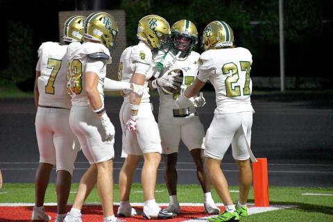 Wesley Branch/The Clayton Tribune. Rabun Gap players swarm teammate Joshua Buckhalter in celebration after Buckhalter’s punt return for a touchdown against Baylor on Aug. 29. The visiting Eagles would fall to the Red Raiders 35-34.