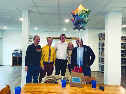Katie Hamby/The Clayton Tribune. Steven Webster, 1 Mill Cups (from left); The Clayton Tribune Publisher Enoch Autry and Sports Editor Wesley Branch; and Kayla Flaherty and Bez Rengifo, 1MC, pose for photo as Tribune was honored. Not pictured, Tribune News Editor Megan Horn, Office Manager Katie Hamby and Senior Sales Associates Debbie Martin and Tony Penrose.