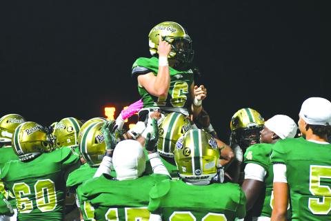 Wesley Branch/The Clayton Tribune. Rabun Gap players lift up quarterback Hector Nahle in celebration after Nahle scores a rushing touchdown versus Christ School in the Eagles’ 42-0 win over the Greenies on Oct. 17. 