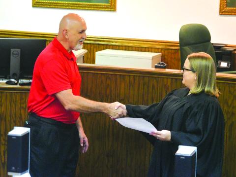 Enoch Autry/The Clayton Tribune. Newly sworn-in Mayor Roy Quilliams shakes the hand of Probate Court Judge Savannah Dixon after he took the oath on Tuesday.