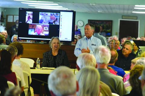 Enoch Autry/The Clayton Tribune. With Sky Valley Mayor Hollie Steil sitting next to him, Jerry Hood, chief executive officer for EMI Engineering Management, talks to the crowd.
