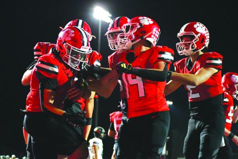 Enoch Autry/The Clayton Tribune. Senior Lake Evans (left) is congratulated by his Rabun County teammates after the running back rumbles 36 yards for a rushing touchdown in the Wildcats’ 55-28 home win over region foe Commerce.