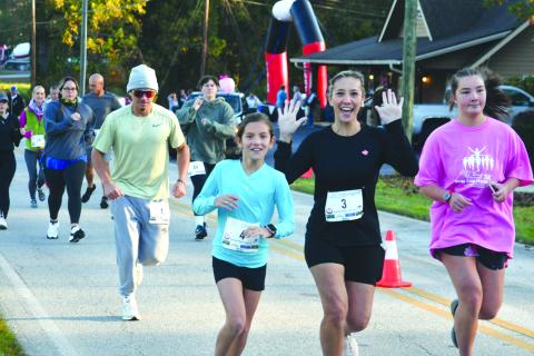 Enoch Autry/The Clayton Tribune. Eden Cullen, Suzanne Cullen and Anna Foster are happy to get the race started on a cool morning in Tiger.