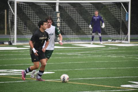 Wesley Branch/The Clayton Tribune. Rabun Gap’s Manuel Uribe dribbles through Christ School defenders in the Eagles’ match versus the Greenies on Sept. 30. The game was rescheduled after the original match was canceled with 28 minutes remaining. 