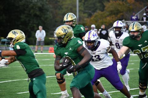 Wesley Branch/The Clayton Tribune. RGNS sophomore running back Royce Djouguem runs through CBC’s defense in the Eagles’ 59-49 loss to the Cadets on Oct. 3. Djouguem ended the game with 48 total yards, 40 of which came on the ground. 