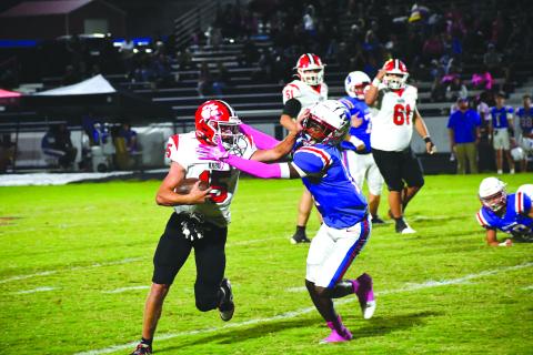 Wesley Branch/The Clayton Tribune. Rabun County running back Reid Giles stiff arms a defender in the Wildcats’ Oct. 10 game against the Patriots at Oglethorpe County. Giles finished the game with 109 total yards and a receiving touchdown. 