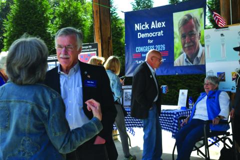 Enoch Autry/The Clayton Tribune. In the foreground, Rabun Countian Nick Alex has a conversation with individuals at the Democratic Party’s 9th Congressional District Blue BBQ in Cllayton on Oct. 11.