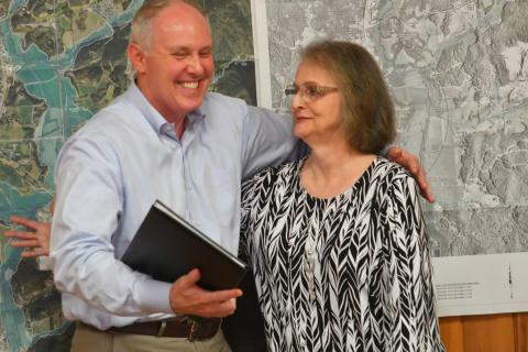 Enoch Autry/The Clayton Tribune. Rick Story hugs Glenda Enloe after Story read a resolution that was penned by Georgia State Rep. Victor Anderson.
