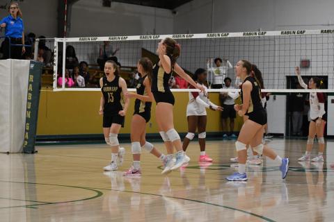 Wesley Branch/The Clayton Tribune. Rabun Gap players celebrate after a 3-2 playoff victory over Cannon on Oct. 10. The win marked the first playoff win for head volleyball coach Zoe Kennedy, and the Eagles’ senior class. 