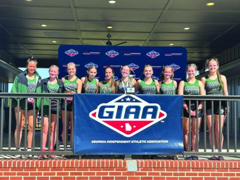 TFS Athletics/The Tallulah Falls girls cross country team shows their state runner-up trophy they claimed in Macon.