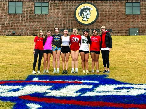 Submitted. The Lady Cats pose for a team photo with head coach April Adcock before the Nov. 8 race.
