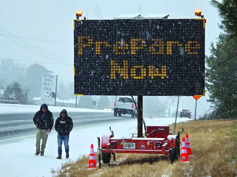 Enoch Autry/The Clayton Tribune. As pedestrians walk along U.S. Hwy. 441 in January 2025, motorists are warned about Winter Storm Cora’s arrival that blanketed Rabun County earlier this year.