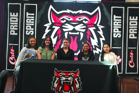 Enoch Autry/The Clayton Tribune. abun County Middle School eighth graders and new REACH scholars Kinley Burtch, Paytn Sharkey, Jasmine Nelson, Neyli Aguilar and Ana Espitia Martinez pose for a photograph at the conclusion of their Nov. 10 signing ceremony.