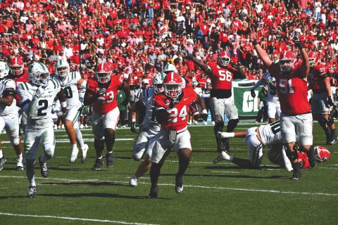 Wesley Branch/The Clayton Tribune. Georgia freshman running back Bo Walker sprints to the end zone for his first career touchdown in Georgia’s 35-3 win over Charlotte on Nov. 22. Walker, who played for Rabun Gap-Nacoochee, scored three rushing touchdowns in the win and ran for 48 yards. UGA plays in-state rival Georgia Tech Friday.