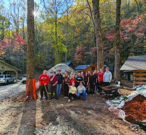 Submitted Photo. The full RCHS group poses for a photograph at Cherokee mud house on the Foxfire Museum property. 