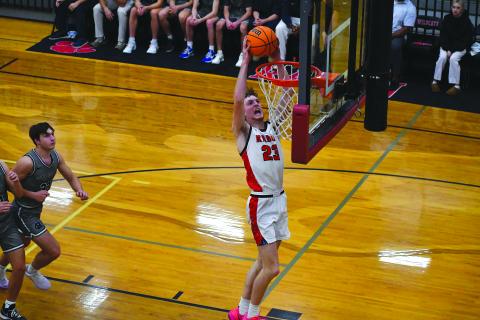 Rabun County senior forward Hayes Free finishes an alley-oop from senior point guard Huey Blalock in Rabun County’s home-opening 83-66 win over White County. Hayes was a preseason All-State selection. 