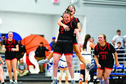 File/Wade Cheek/The Clayton Tribune. Rabun County’s Adelyn Thompson celebrates with Addy Beth Owens after knocking down the game-winning shot against Armuchee High School in the first round of the state playoffs last season. The Lady Wildcats advanced to the Elite Eight for the 10th time in history.