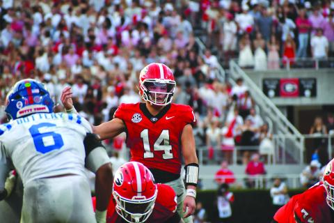 Wesley Branch/The Clayton Tribune. Former Rabun County and current UGA quarterback Gunner Stockton prepares to take a snap in Georgia’s 43-35 win over Ole Miss on Oct. 18. Stockton threw for 289 yards and four touchdowns, while running for 59 yards and a score in the win.  Ole Miss now will face UGA in the playoffs on New Year’s Day.