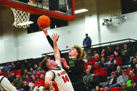 Wesley Branch/The Clayton Tribune. abun Gap junior Joonatan Tartu shoots over Rabun County freshman Cord Burrell for a contested layup against Rabun County on Dec. 19. Rabun County took the win 64-59, improving to 9-1 while Rabun Gap fell to 10-5.
