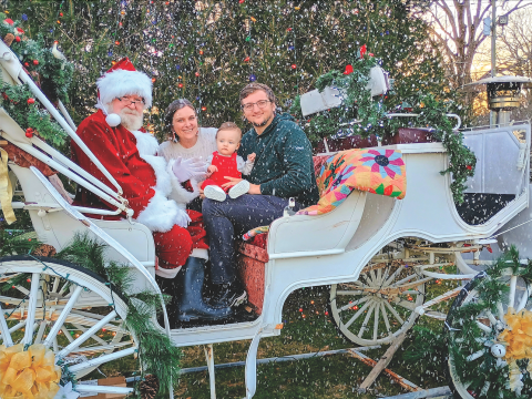 Megan Horn/The Clayton Tribune. It was a winter wonderland in Dillard Saturday, Dec. 13, at the inaugural “Dickens in Dillard” Christmas Festival. Santa, Katelyn See, Beckett See, 1, and Parker See pose on The Dillard House carriage with snow provided by Big Idea Blizzard coming down. 