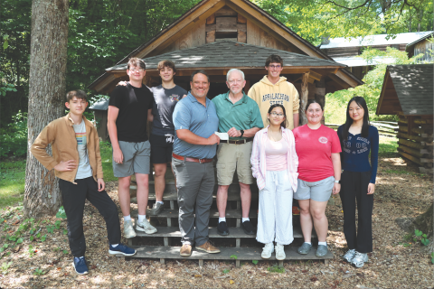 Rabun Youth Educational Support, Inc., (RabunYES), donated over $10,000 to the Summer Project Foxfire youth program. Tom Buckridge, RabunYES treasurer, had the chance to speak to program students and present the check to Foxfire Executive Director Todd Faircloth. The donation was made in honor of Buckridge’s late wife, Jean, whose passion was to help young people. Pictured are Jaden Shurtliff, left, Caden Watt, Sean Flaherty, Faircloth, Buckridge, Wyatt Arbitter, Tara Shyrock, Abby Streetman and Sunny Lin.