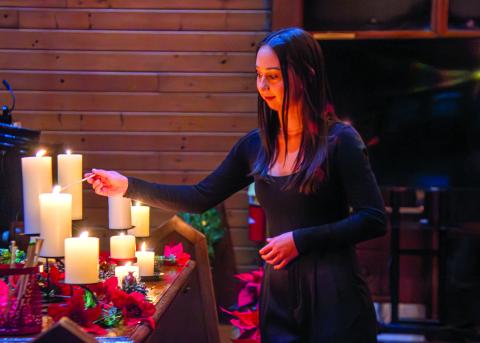 Submitted photo. Representing the senior class, Charlotte Stafford lights one of the candles at the TFS Candlelight service. Class members decide on the student who best represents their class in character and intellect.