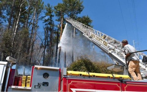 File/Megan Horn/The Clayton Tribune. Josh Bleckley, Rabun County Fire Services Station 2 Captain, operates Ladder 1 for a brush fire on Clayburne Street in Clayton on March 25. This happened around the same time as United States Department of Agriculture (USDA) Forest Service crews battled a fire burning in the Warwoman Wildlife Management Area between Sarah’s Creek and Walnut Fork, north of Warwoman Creek in Rabun County.