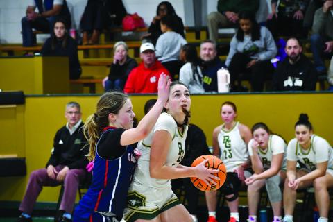Wesley Branch/The Clayton Tribune. Rabun Gap senior Lydia McNabb fights off a Carolina Day defender in Rabun Gap’s 59-27 win over Carolina Day on Jan. 8. The Lady Eagles had over three weeks in between games due to the holiday break. 
