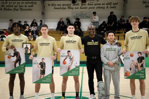 Photo courtesy Rabun Gap Athletics. Rabun Gap basketball seniors pose for a picture with first-year head coach Devin Liferidge (center) ahead of the Eagles’ 59-46 win over Asheville School on Feb. 7. The Eagles are 16-9 on the season with two games remaining before the state playoffs.