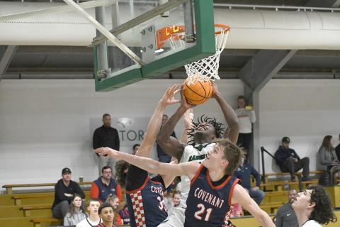 Wesley Branch/The Clayton Tribune. Rabun Gap senior RJ Lacossade fights through the Covenant Day defense for a layup in Rabun Gap’s 56-49 win over Covenant Day School on Feb.17. Lacossade, a captain for the Eagles, has helped lead the program to the state playoffs each of the last three seasons. 