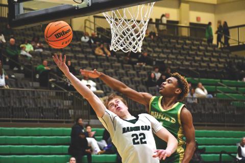 Wesley Branch/The Clayton Tribune. Rabun Gap-Nacoochee School junior Joonatan Tartu fights through the Buford defense for an and-one layup in Rabun Gap’s 61-56 win over Buford on Jan. 30. Tartu converted the and-one pictured above and made an important block late in the game in the Eagles’ victory.