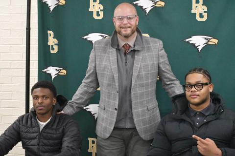 Wesley Branch/The Clayton Tribune. Rabun Gap head football coach Derek White (center) poses with Rabun Gap seniors CJ Willingham (left) and Devon Holly (right) on Feb. 5 at Rabun Gap’s signing day recognition for Willingham and Holly. Willingham will continue his football and academic careers at Columbia University, while Holly signed to North Carolina A&T. 