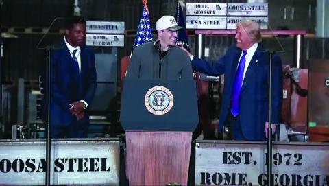Video image/Fox5 Atlanta. Rabun County standout and current Georgia quarterback Gunner Stockton is greeted at the podium in Rome, Ga., on Feb. 19 by President Donald Trump. Standing with Stockton and Trump is Herschel Walker, Bulldog great and current ambassador to The Bahamas.