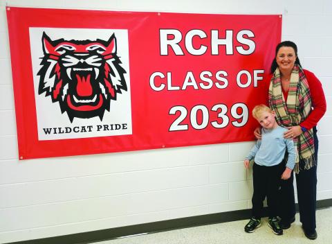 Megan Horn/The Clayton Tribune. Pre-K student Camdyn Darnell, 5, and Rabun County Primary School (RCPS) Principal Carla Truelove pose beside the “RCHS Class of 2039” sign that hangs in the Pre-K hallway. 2026-2027 Pre-K Lottery registration begins March 1 and ends March 13 at 4 p.m. 