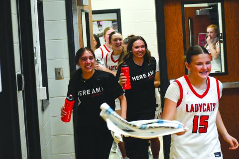 Wesley Branch/The Clayton Tribune. The Rabun County girls basketball team chases after head coach DeeDee Dillard with water bottles after Dillard sprinted out of the locker room back onto the court, following Rabun County’s 56-43 win over Model at home in the Sweet 16 on Feb. 27 to advance to the Elite Eight against Thomasville.