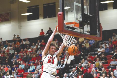 Wesley Branch/The Clayton Tribune. Rabun County senior Hayes Free throws down a powerful dunk in the Wildcats’ 84-52 win over Heard County Feb. 28 in the GHSA state playoffs. Free and the Wildcats have set a school season record with 27 wins. 