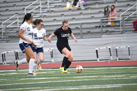 Wesley Branch/The Clayton Tribune. Rabun County freshman Millie Southards fights off Elbert County defenders in Rabun County’s 9-1 win over Elbert County on March 6 at home. Southards scored three goals in the win. 