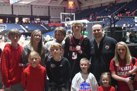 Wesley Branch/The Clayton Tribune. The Adcock family and Page family have become closer this season as Corey Page came on as an assistant coach for head coach David Adcock. April Adcock, David’s wife (second from left in back), said they prayed the right person would come to be the assistant coach and that right person was Corey Page. This photograph of the two families was taken in the Macon Coliseum after the Wildcats won the state title.