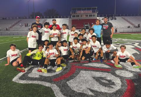 Submitted photo. The Rabun County Middle School boys soccer team poses with the region-winning trophy after defeating Habersham County 2-0 in the championship game on March 14.