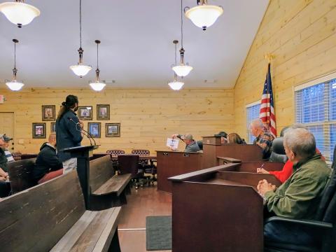Megan Horn/The Clayton Tribune. Tiger council member John Grist asks Alim Dhanani, co-owner of KASA 4 LLC and Tiger BP, center, a question about the plan for ingress/egress on the property if a rezoning request from Residential to Commercial is approved for the addition of gas pumps. Grist holds a rough sketch of the plan that was provided to meeting attendees as well. Aslam Dhanani is the other owner.