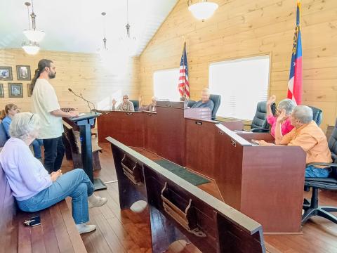 Megan Horn/The Clayton Tribune. Tiger Town council members unanimously vote March 9 to approve a rezoning request from Residential to Commercial at 26 Bridge Creek Rd. in Tiger. The property is adjacent to the Tiger Biscuit Place (BP) General Store. The purpose of the rezoning is to add gas pumps at the Tiger four-way intersection. Pictured center is Alim Dhanani, owner of Tiger BP. The other owner is Aslam Dhanani. 
