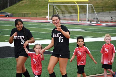 Wesley Branch/The Clayton Tribune. Denise Zaldivar and Hayden Bass were among the Lady Cats who walked with Rabun County Recreation Department soccer players as part of “Rec Night” on March 31 at Frank Snyder Memorial Stadium.