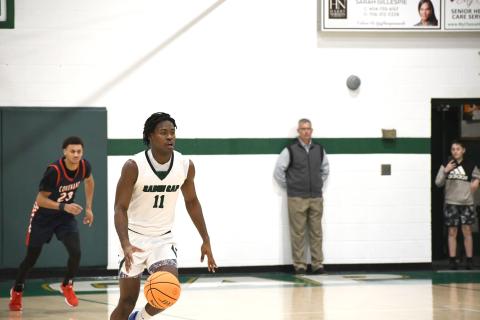 Wesley Branch/The Clayton Tribune. Rabun Gap senior RJ Lacossade races down the floor during Rabun Gap’s 56-49 playoff win over Covenant Day on Feb. 17. Lacossade is just the seventh basketball player from Turks and Caicos to make it to the collegiate level. 