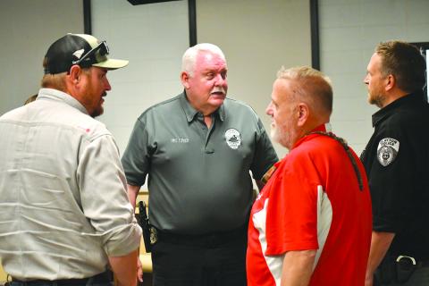 Enoch Autry/The Clayton Tribune. Newly hired Clayton Police Chief Mike Turner (center) talks with council member Channing Watts, Planning and Zoning Administrator Richard Moncus and interim Police Chief Lt. Matt Thomas at the conclusion of Tuesday’s meeting at city hall. Turner’s start date in Clayton is May 1.