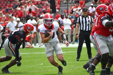 Wesley Branch/The Clayton Tribune. Current UGA and former Rabun County quarterback Gunner Stockton evades defensive pressure from the Black Team in Georgia’s ‘G-Day’ scrimmage. Stockton finished the afternoon 7-of-12 passing for 76 yards and a touchdown for the red team in a 27-17 victory.