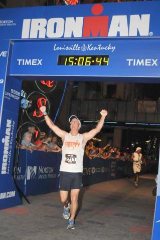 Submitted photo. Mark Holloway reacts to completing an Iron Man competition in Louisville, Ky. He will run the New River Marathon in Todd, N.C.,in May to raise up to $10,000 for Women of Worth and its first class of its recovery program. 