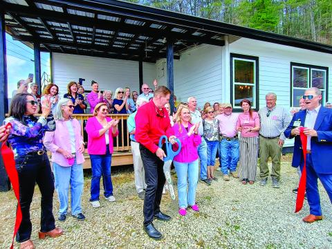 Megan Horn/The Clayton Tribune. Community members celebrate and show support on March 31 to the nonprofit Women of Worth (WOW) Recovery as the ribbon is cut on the first residential substance-abuse recovery center in Rabun County. Forward Rabun/Rabun County Chamber of Commerce held an official ribbon cutting and grand opening celebration. It is located at 5989 Highway 441, Lakemont, and can be reached by telephone by contacting 706-782-9761.